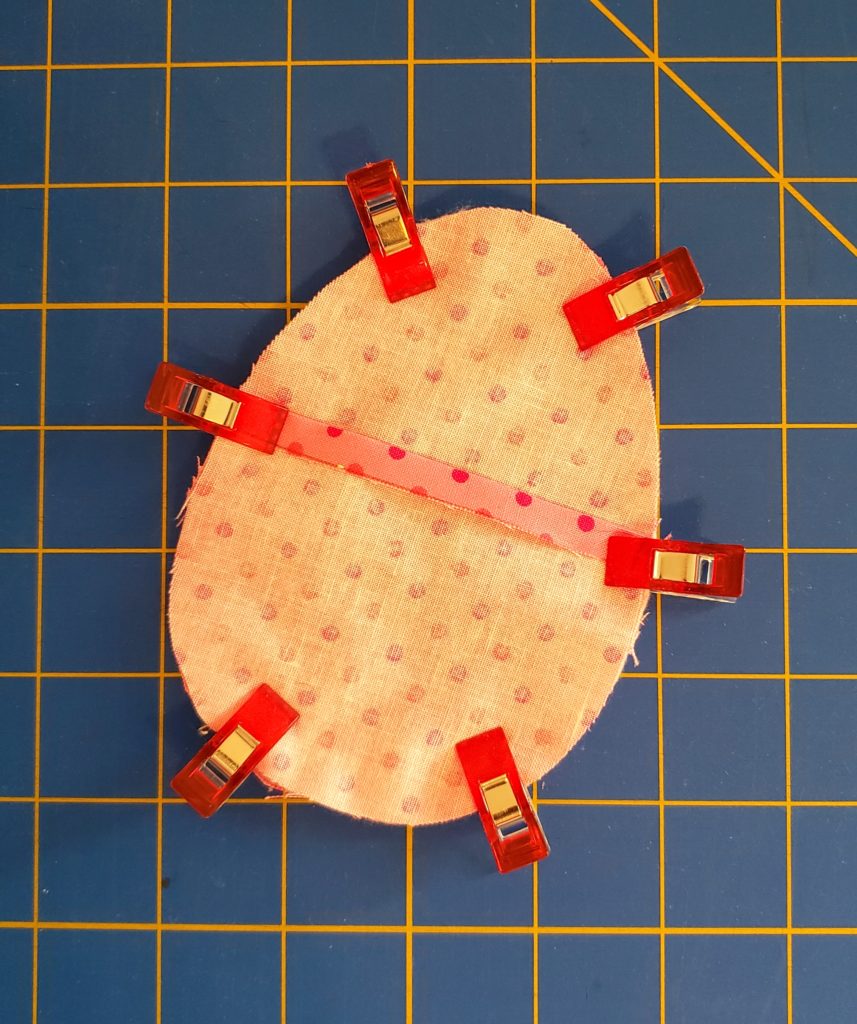 Layers of fabric egg clipped together and ready to sew